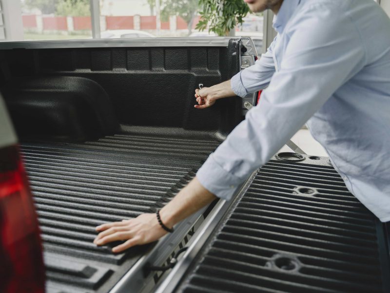 Man admiring his new protected truck bed liner