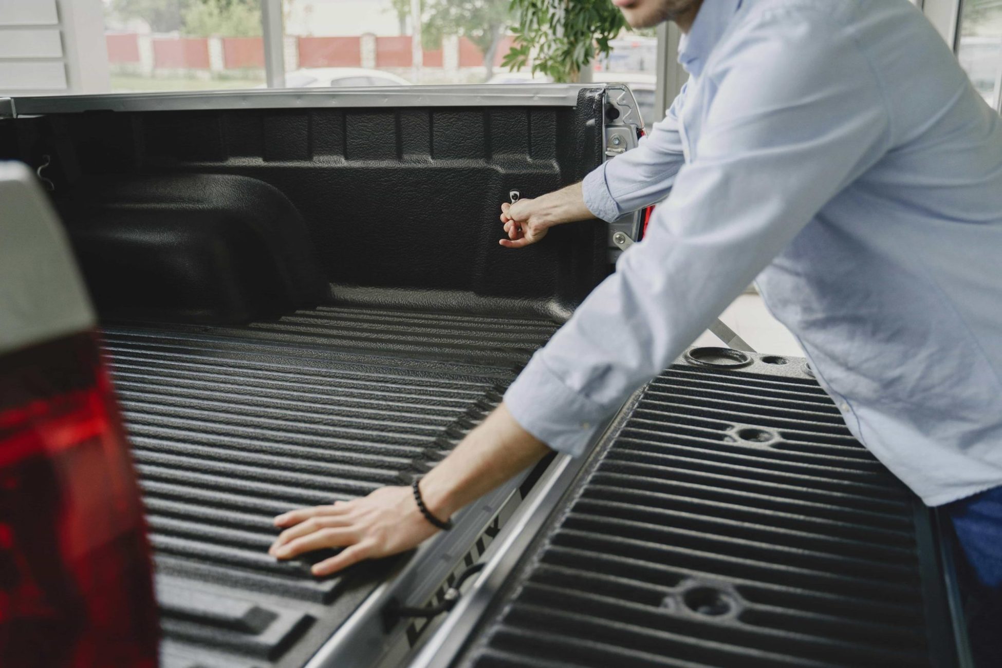 Man admiring his new protected truck bed liner